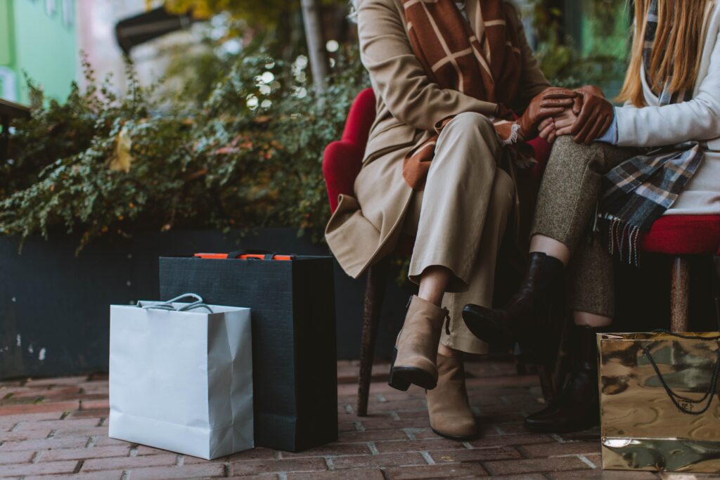 People sat down with shopping bags
