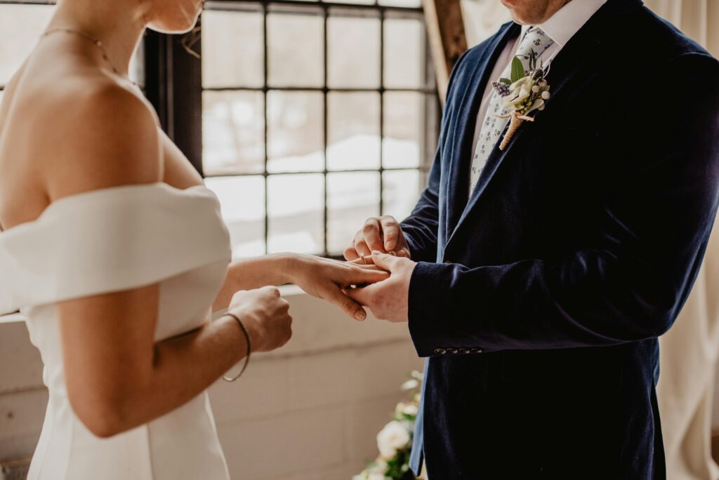 Bride and groom exchanging rings at a wedding