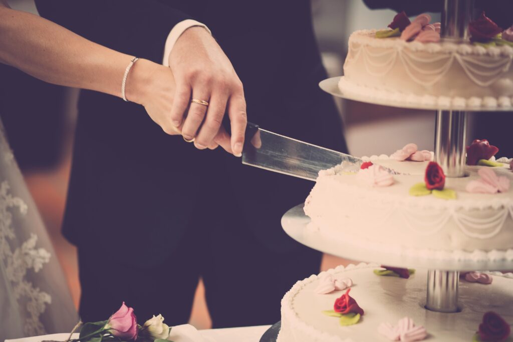 Bride and groom cutting cake at a wedding