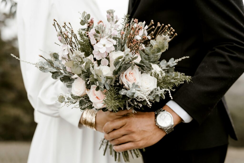 Bride and Groom holding flowers at a wedding